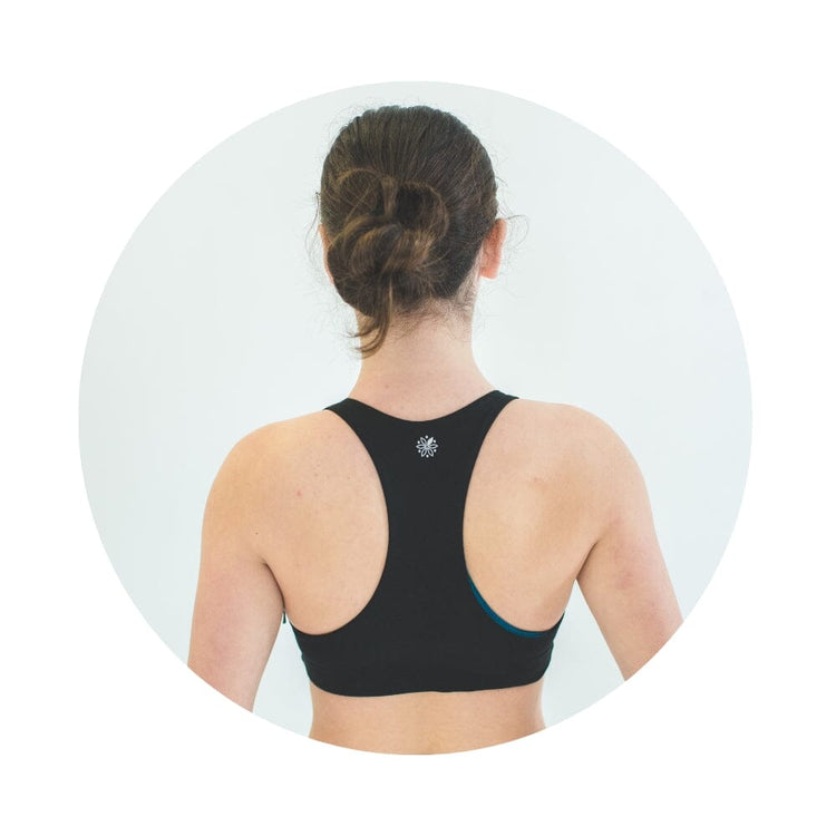 A young woman from back wearing a black racerback bra