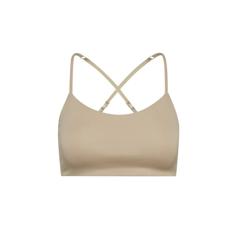 Close-up view beige Bleum Active Bra with crisscross straps