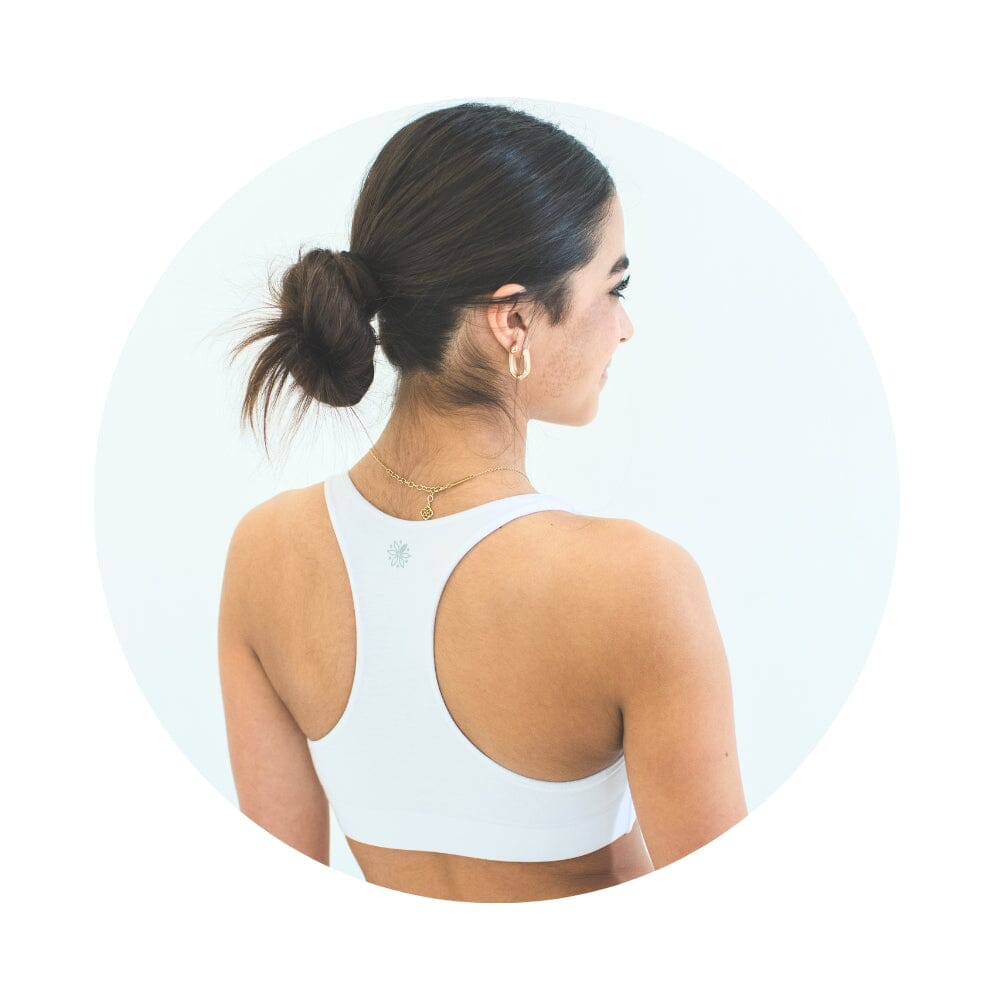 White-White#White Organic Bras & Bralettes For Girls, Tweens and Teens - Front view of a white racerback bra with a small gray emblem in the center.