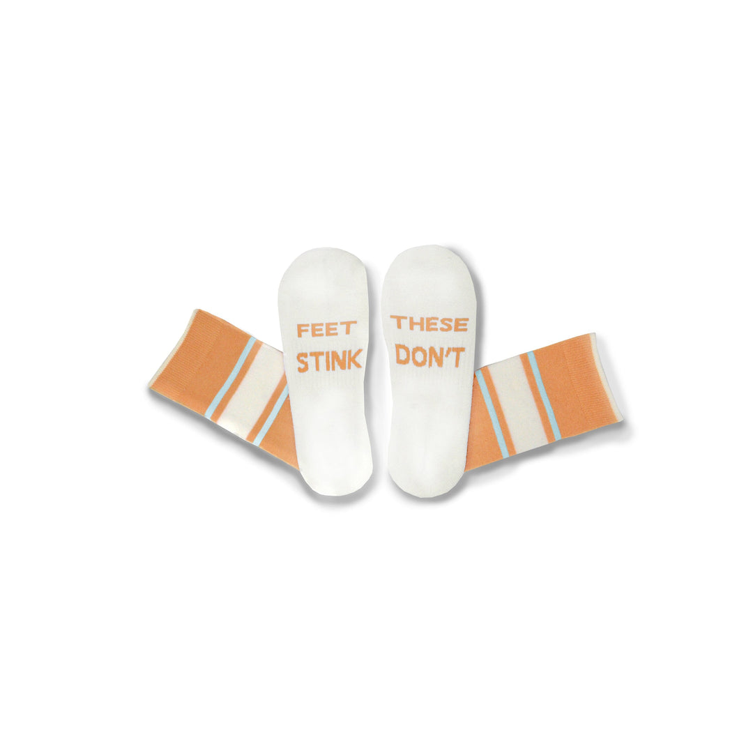Orange#A pair of white socks with orange and light blue stripes, featuring the text 'FEET STINK' on one sock and 'THESE DON'T' on the other, displayed against a plain white background.