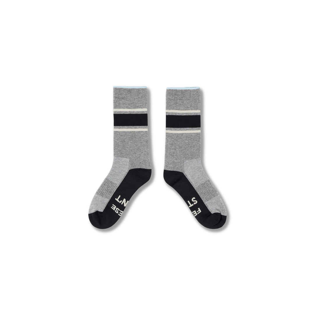 Black-Grey#A pair of crew socks in heather gray with black and white stripes near the cuff, black toes and heels, and white text branding on the soles, shown against a plain white background.