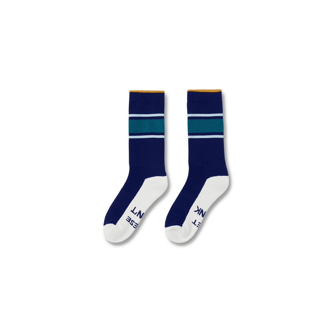 Navy#A pair of crew socks with a navy blue body, teal and white horizontal stripes near the cuff, a thin yellow stripe above the cuff, and white toes and heels. The brand name 'LUNAK' is printed in navy on the sole of one sock, set against a plain white background.