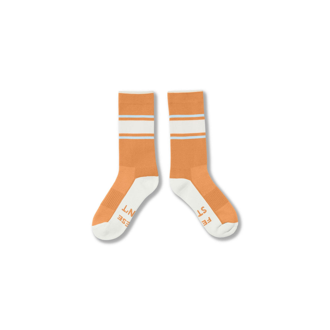 Orange#A pair of crew socks in orange and white, featuring horizontal white stripes near the cuff and text printed on the toes, displayed against a plain white background