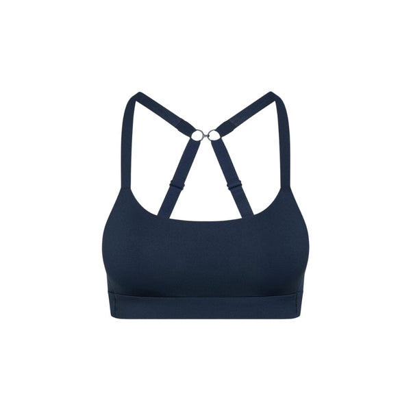Navy teen sports bra with thin x-back straps on a white background from front
