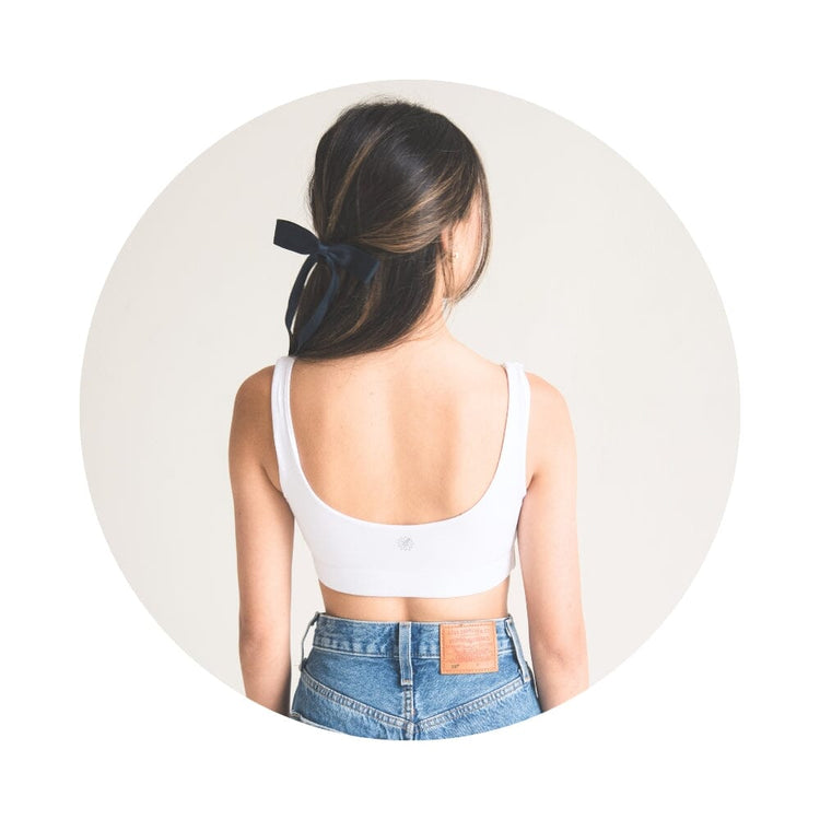Front view of girl wearing white color aster organic tank bra.
