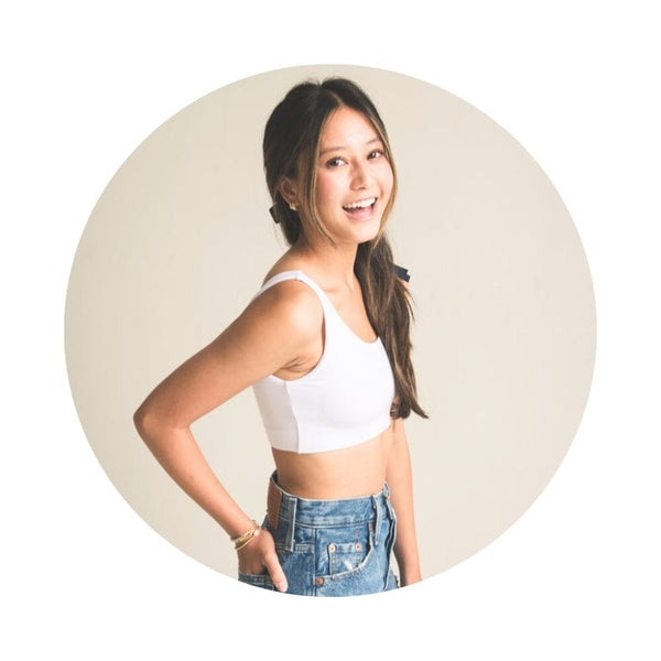 Front view of girl wearing white color aster organic tank bra.