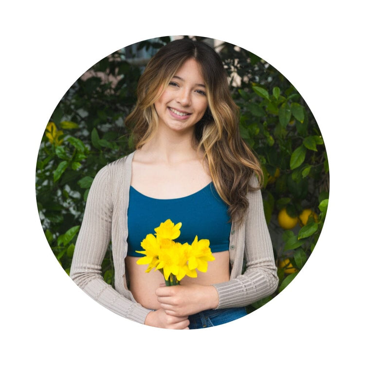 Girl holding flowers wearing dark blue bra