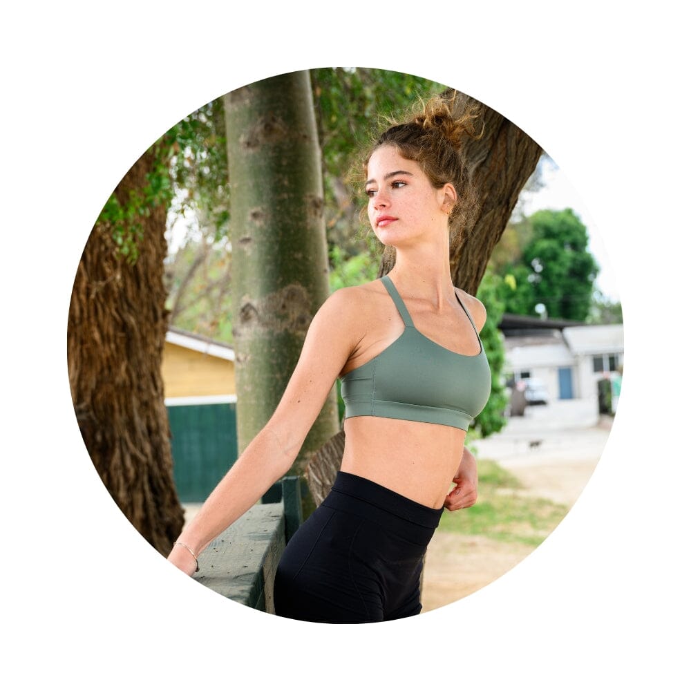 Sage#Girl in best teen sports bra in sage green from side in park