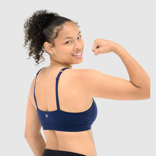 Navy#Girl in Navy teen sports bra on a pink background