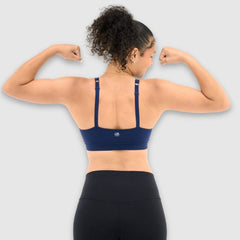 Navy#Girl in Navy teen sports bra on a pink background