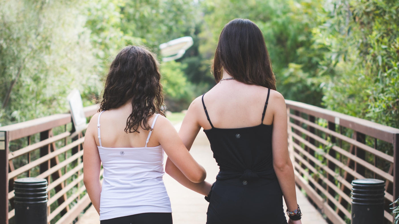 Two teen girls walking across a bridge wearing Bleuet Bleum girls camisoles 