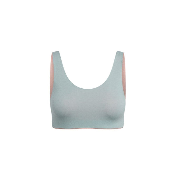 Light green Aster Organic Tank Bra with a pink inner lining, front view.