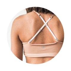 Caramel-Persimmon#Close-up rear view of a model wearing a caramel-colored Bleum Active Bra by Bleuet-girl, showcasing the brand logo and the crisscross back design.