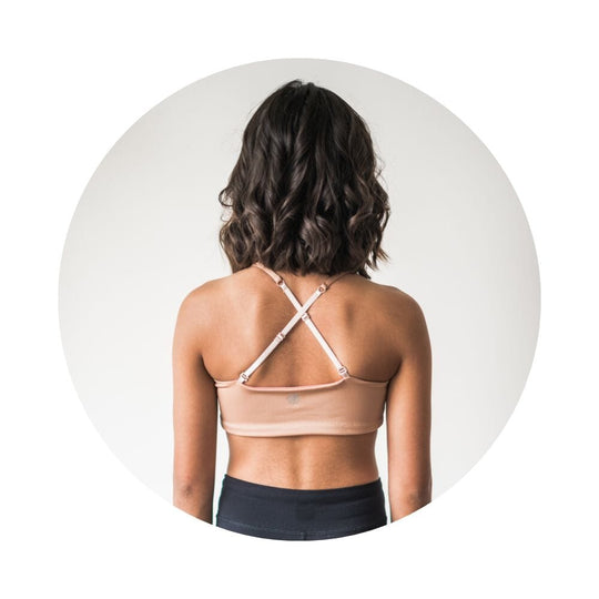Caramel-Persimmon#A rear view of a model wearing a nude-colored Bleum Active Bra by Bleuet-girl, showcasing its crisscross back straps. Sports Bras & Bralettes For Girls, Tweens and Teens