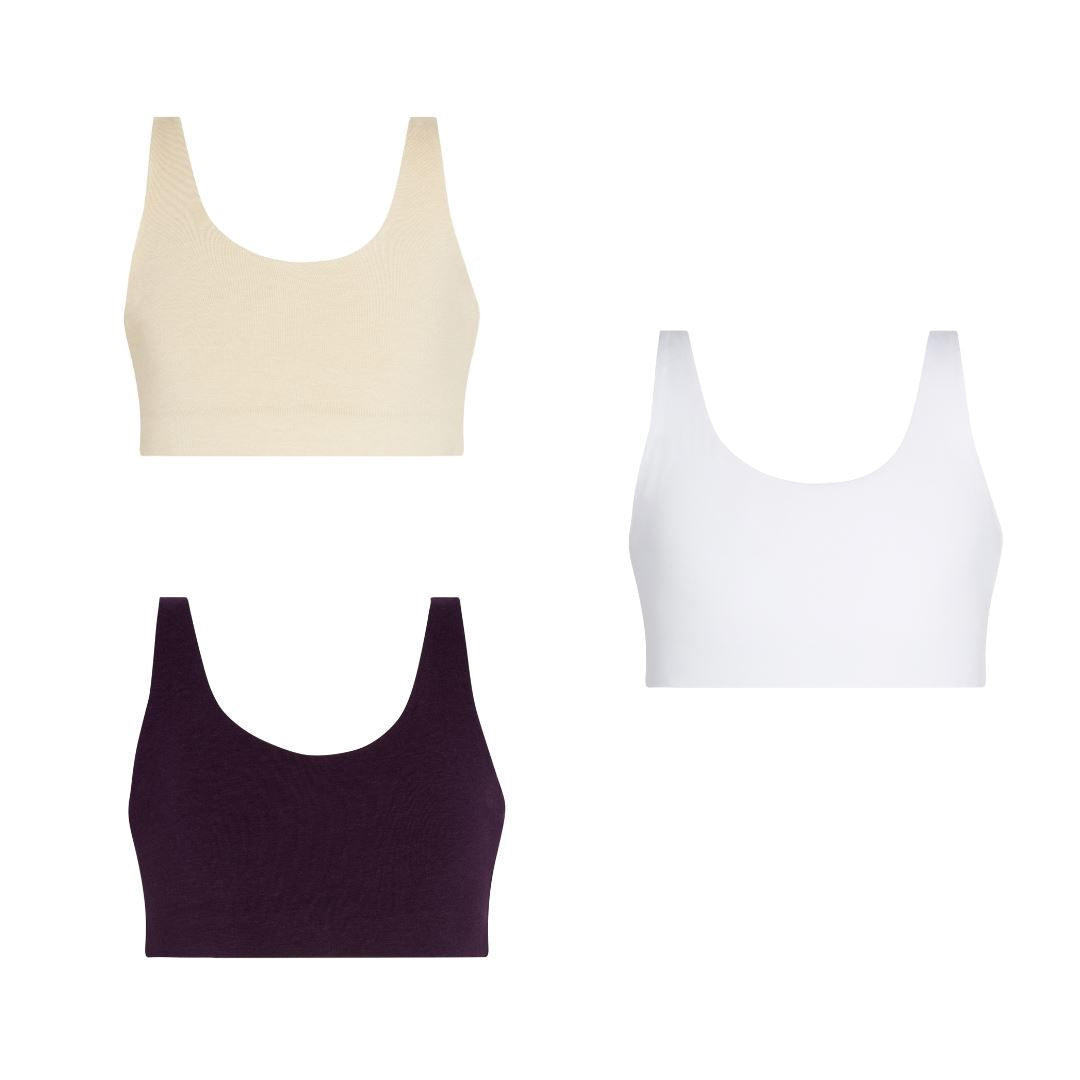 Aster Bra Bundle#Three bras in beige, white, and plum colors arranged vertically on a white background.