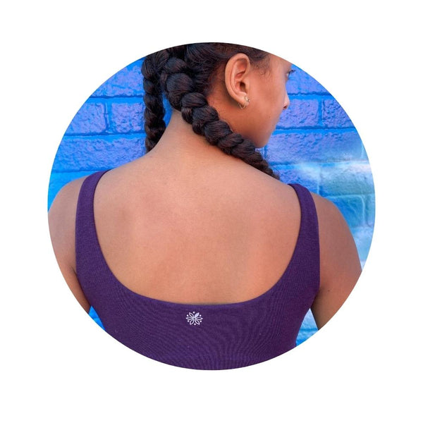 Back view of a woman wearing a violet aster organic tank bra.
