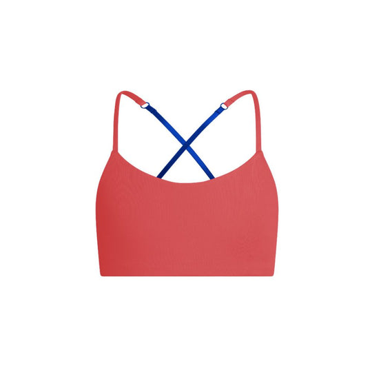 Blue-Persimmon#A red Bleum Active Bra by Bleuet-girl shown from the front, with blue straps.